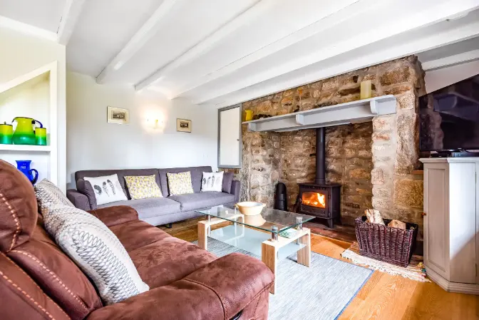 The Cottage living room with seating area and fireplace